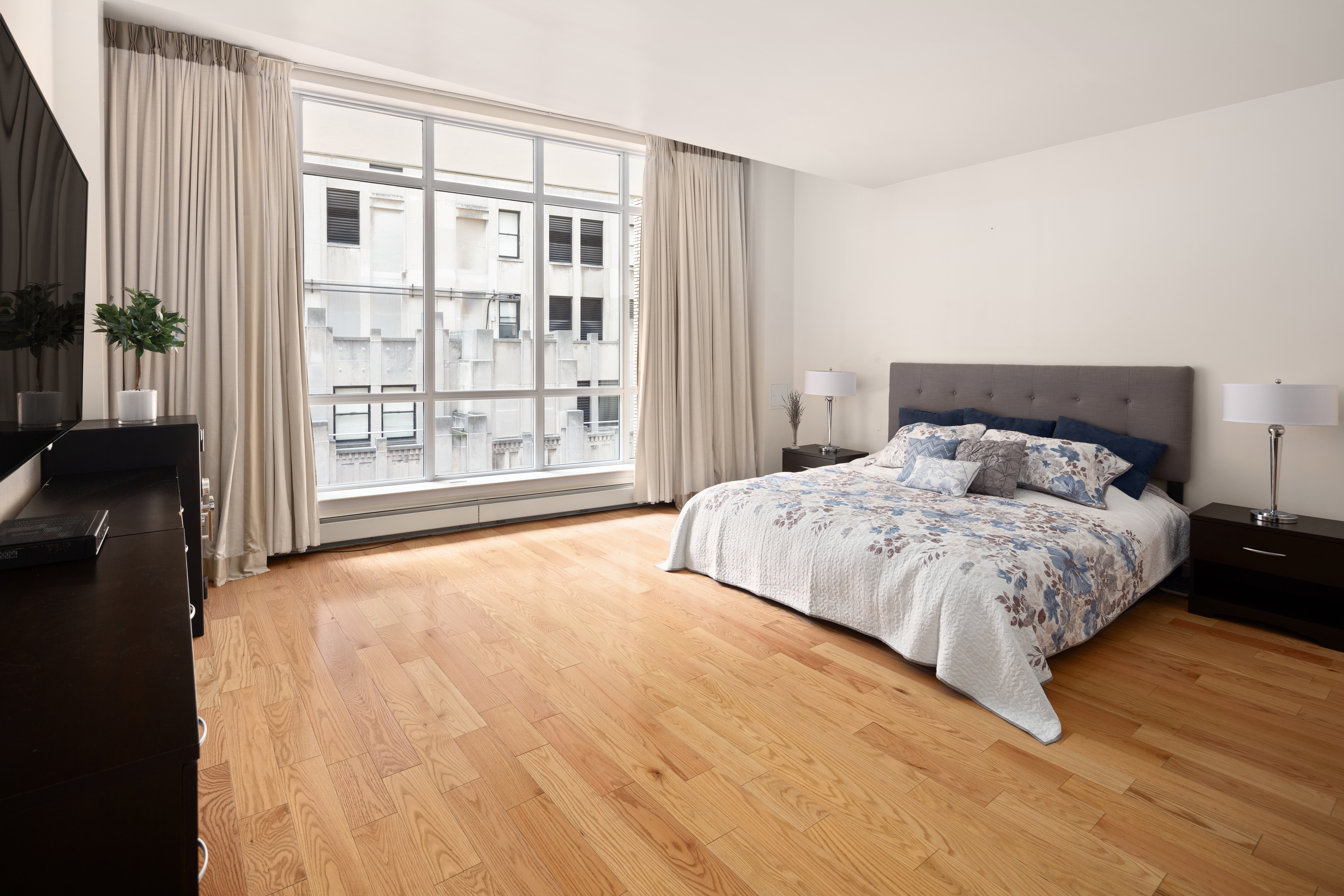 59 John Street, Unit PH1 Manhattan, NY 10038 - Photo 7 of 15 a bedroom with a large bed and a large window