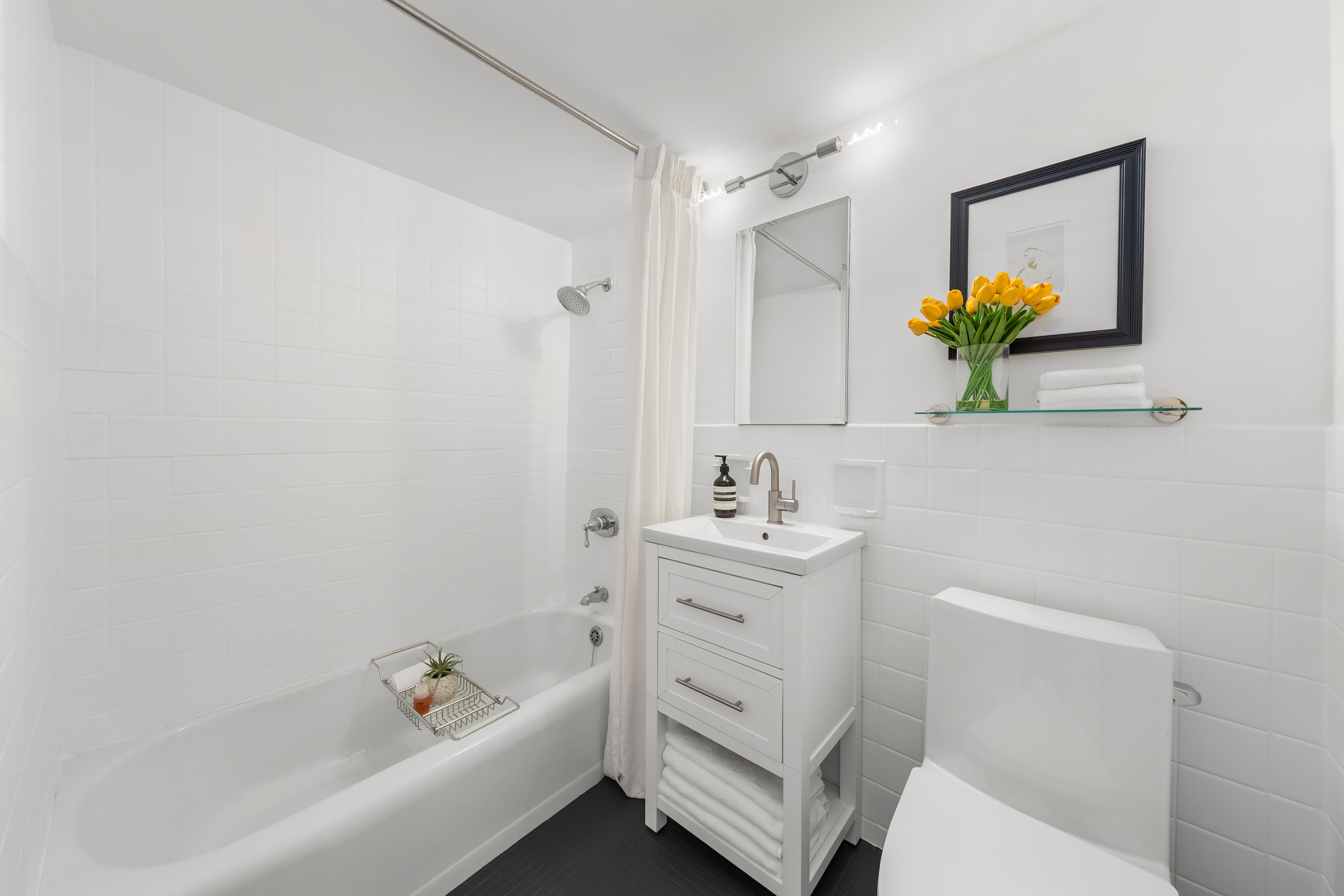 700 Park Avenue, Unit 2B Manhattan, NY 10021 - Photo 15 of 26 a bathroom with a sink a toilet and vanity