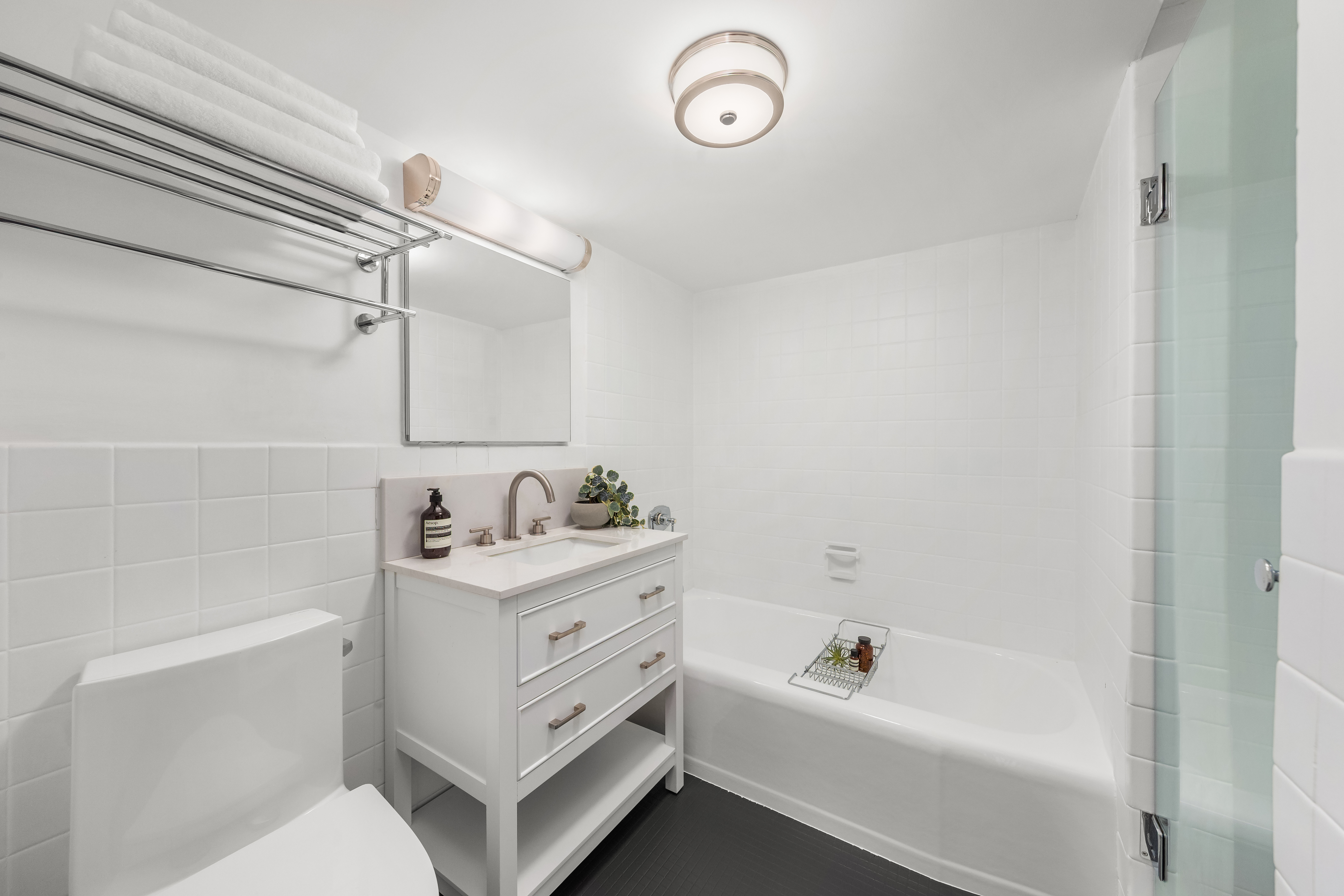 700 Park Avenue, Unit 2B Manhattan, NY 10021 - Photo 13 of 26 a bathroom with a bathtub a sink a toilet and a shower