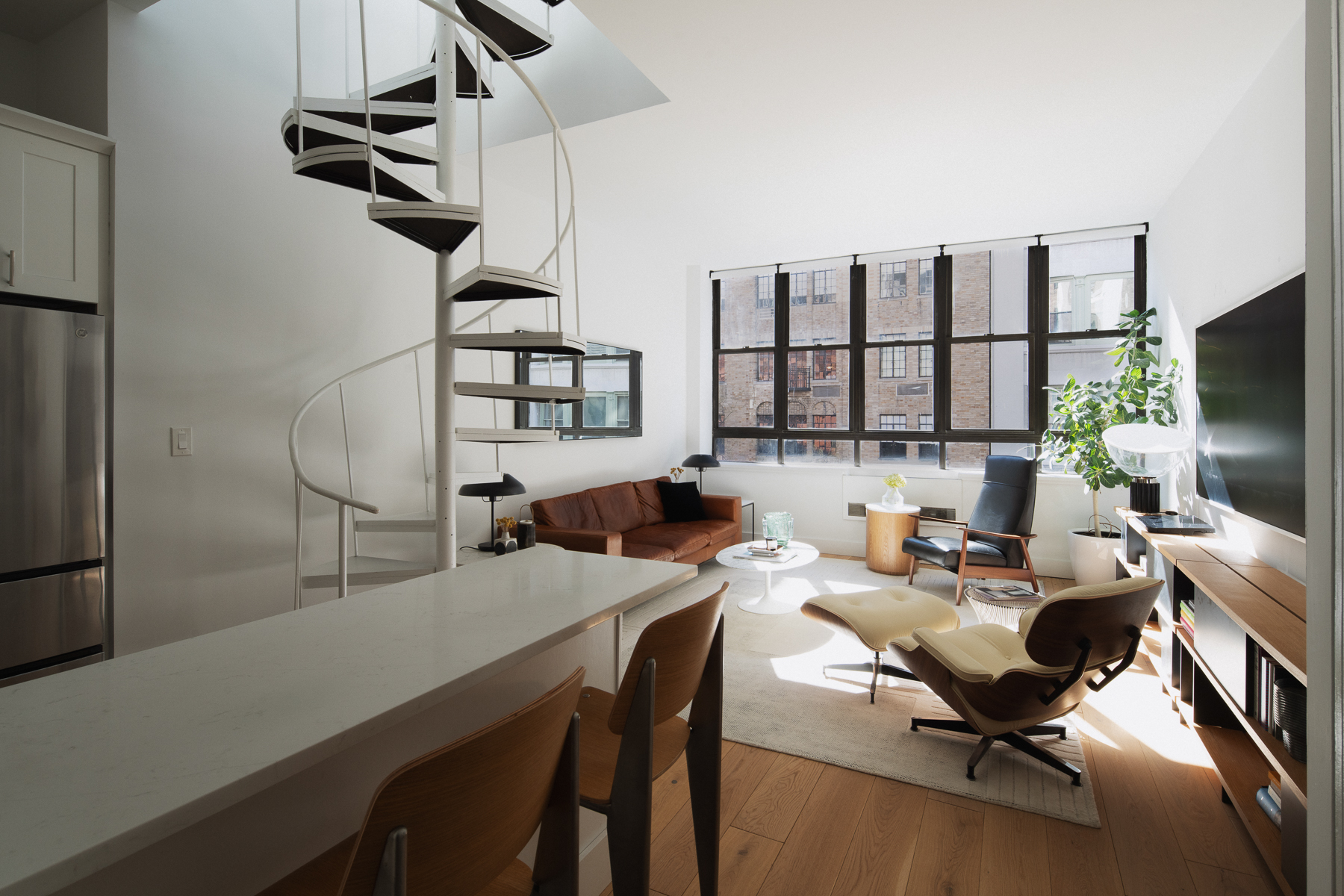 35 East 10th Street, Unit 4J Manhattan, NY 10003 - Photo 4 of 19 a work room with furniture and a flat screen tv