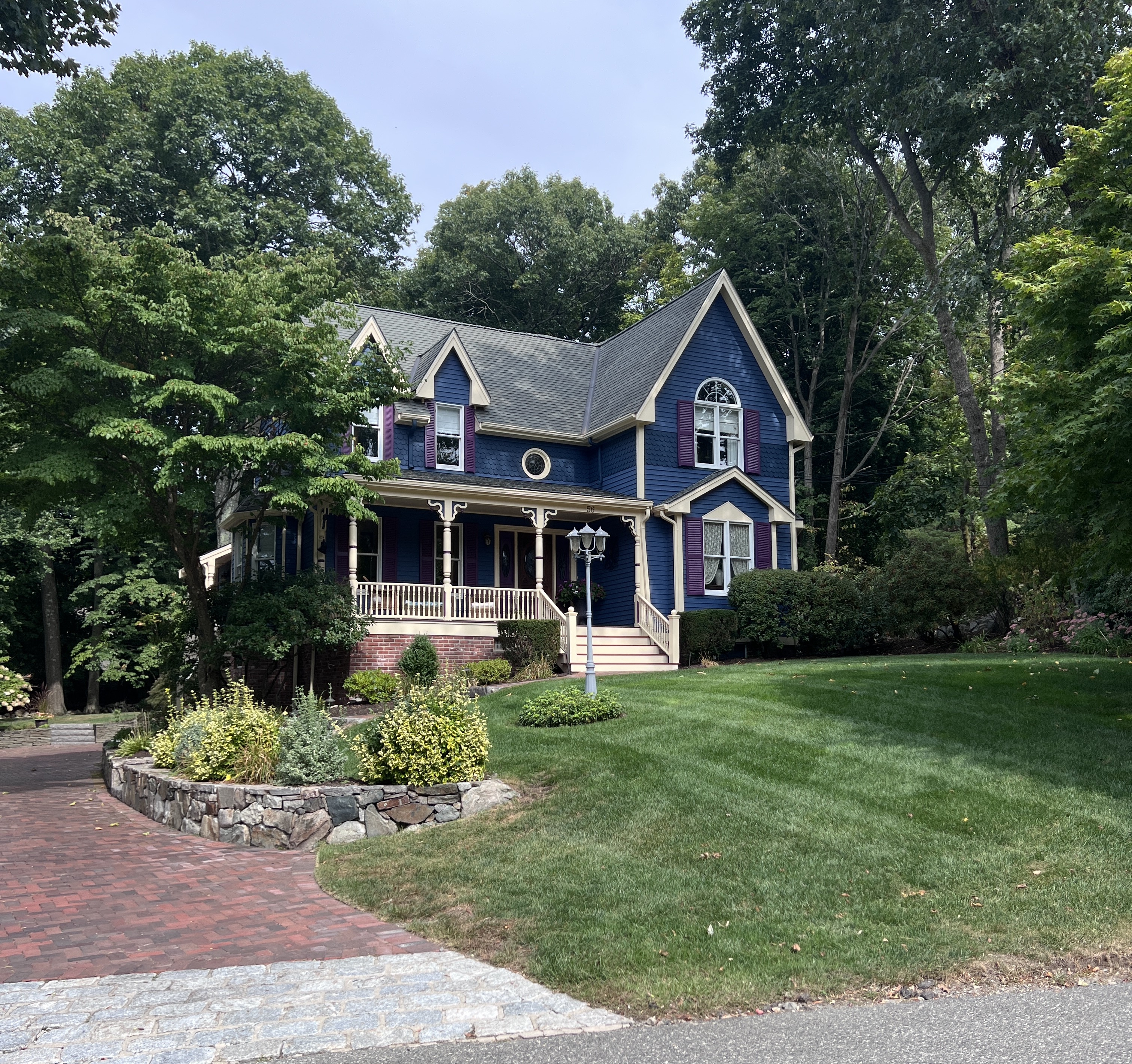 a front view of a house with a garden
