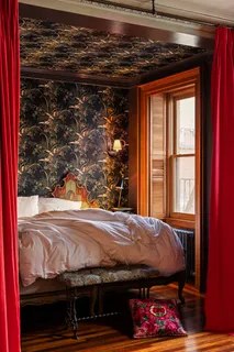 a bedroom with a bed and a window