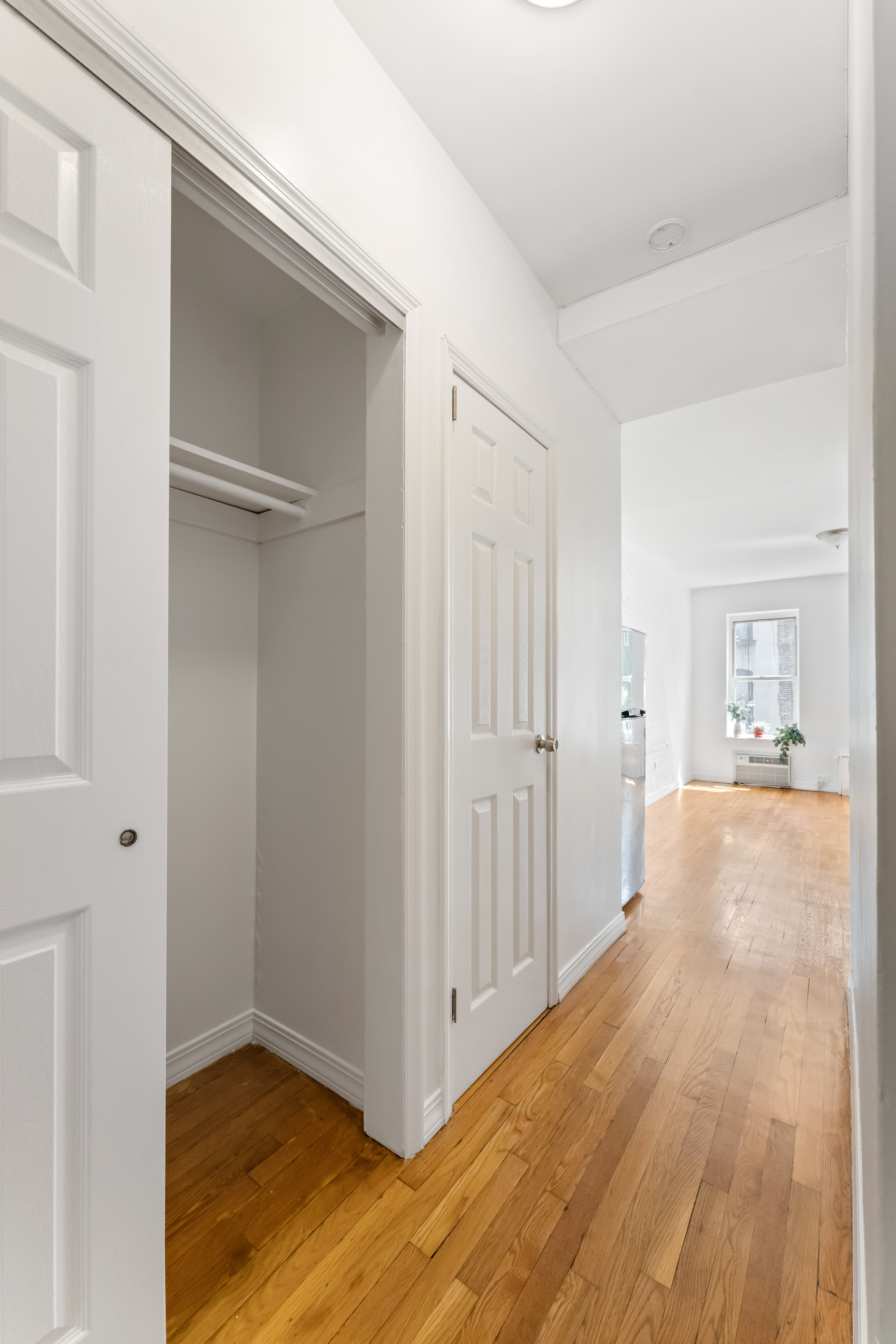 482 East 74th Street, Unit 5C Manhattan, NY 10021 - Photo 5 of 8 a view of an empty room with wooden floor