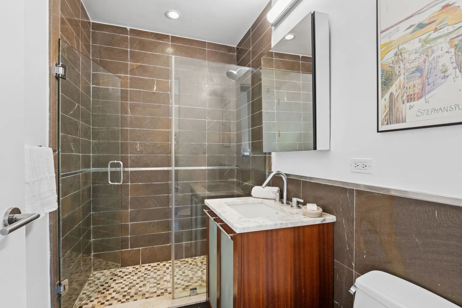 a bathroom with a sink mirror toilet and shower
