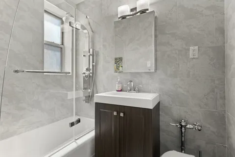 a bathroom with a sink mirror toilet and bathtub