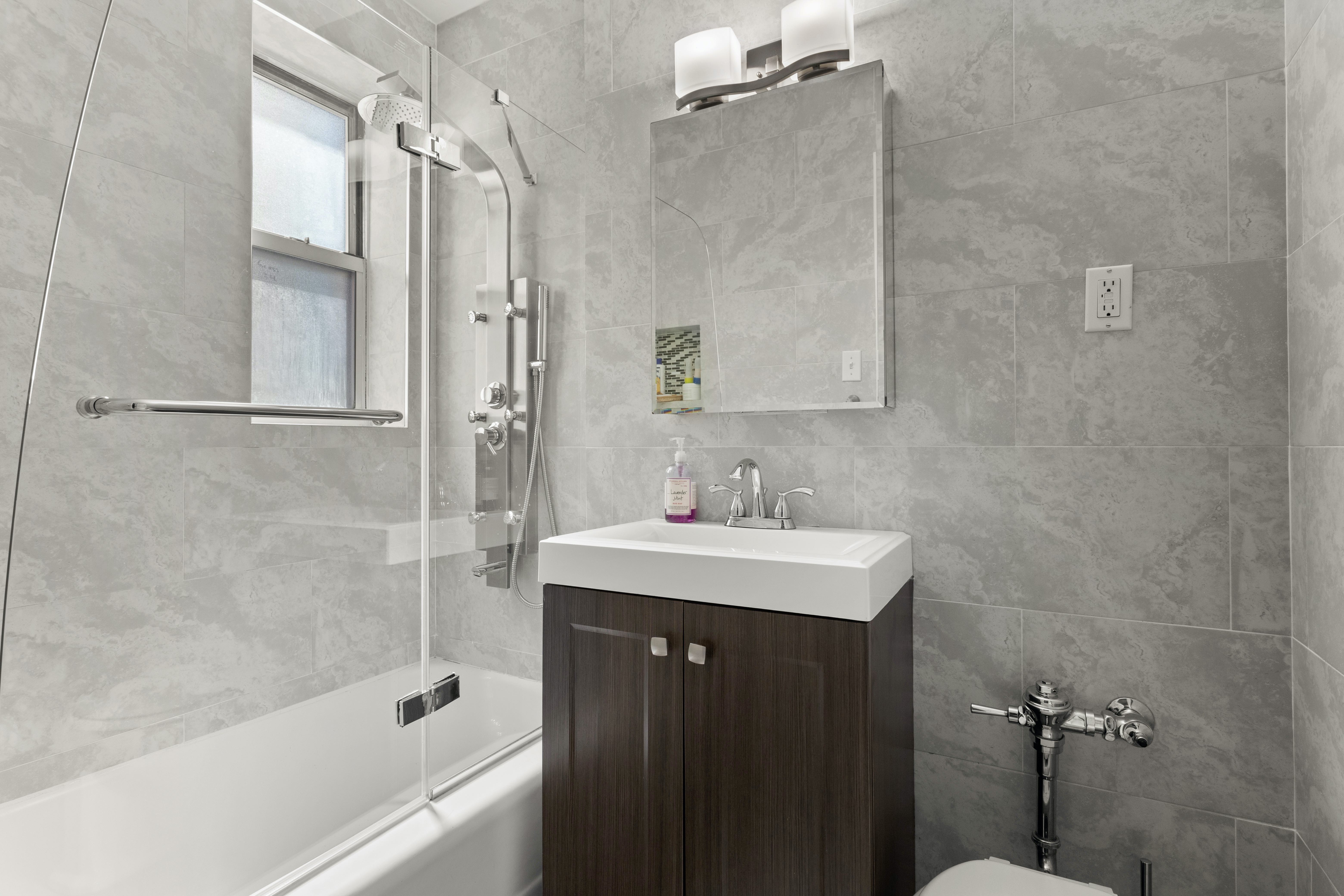 66 Overlook Terrace, Unit 4K Manhattan, NY 10040 - Photo 16 of 26 a bathroom with a sink mirror toilet and bathtub