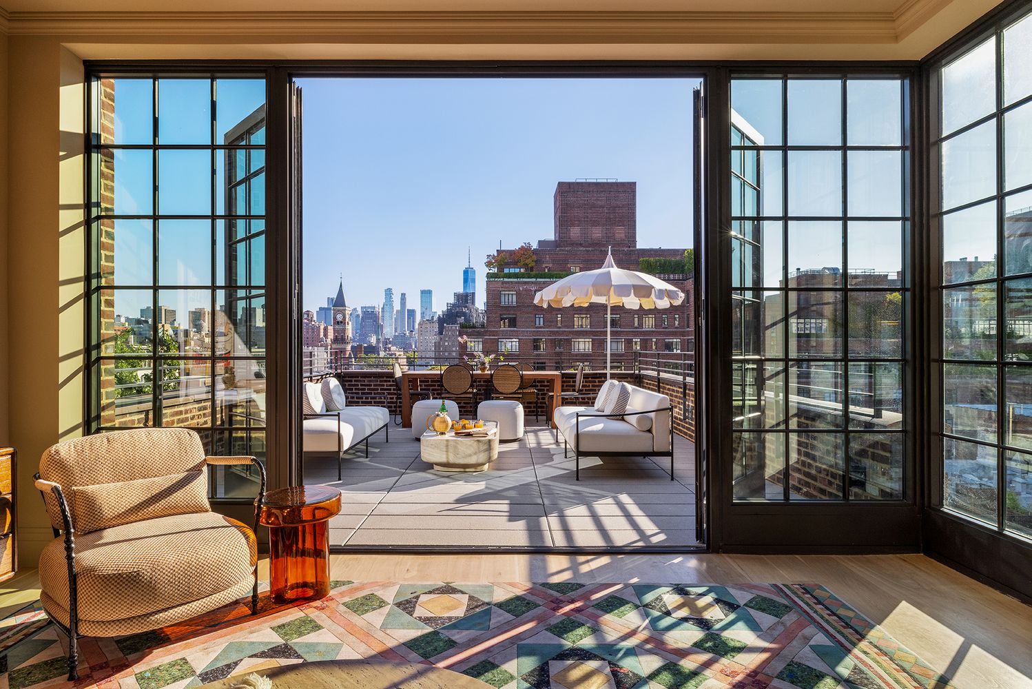 a living room with furniture and a floor to ceiling window