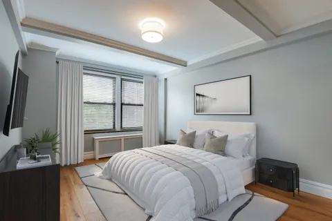 a bedroom with a large bed and a potted plant