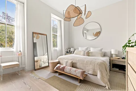 a bedroom with bed and a chandelier