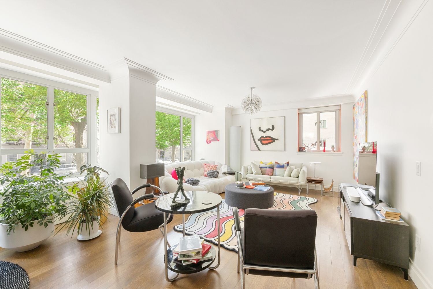 a living room with furniture and a potted plant