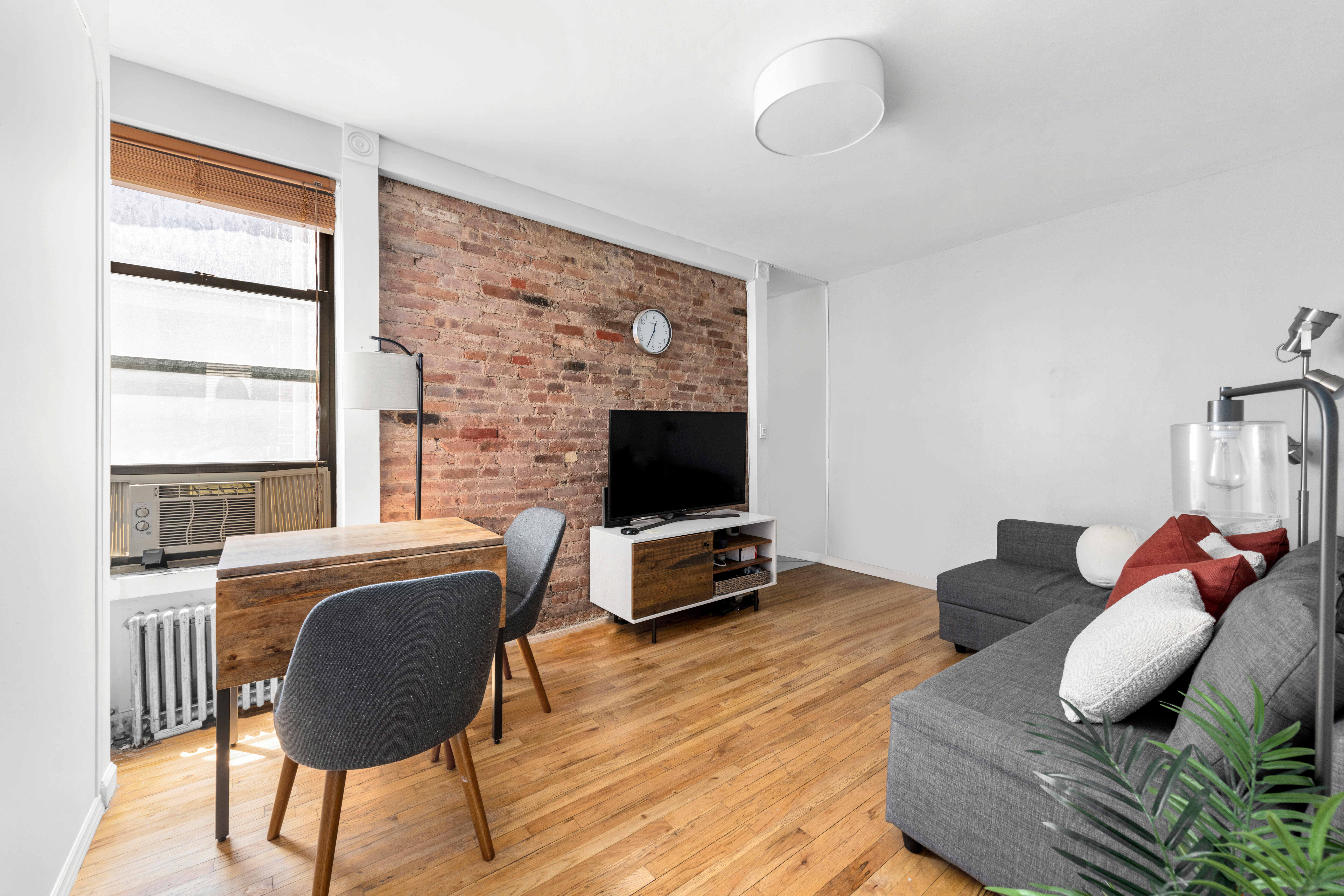 321 East 12th Street, Unit 24 Manhattan, NY 10003 - Photo 2 of 8 a living room with furniture fireplace and a flat screen tv