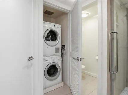 a utility room with sink dryer and washer