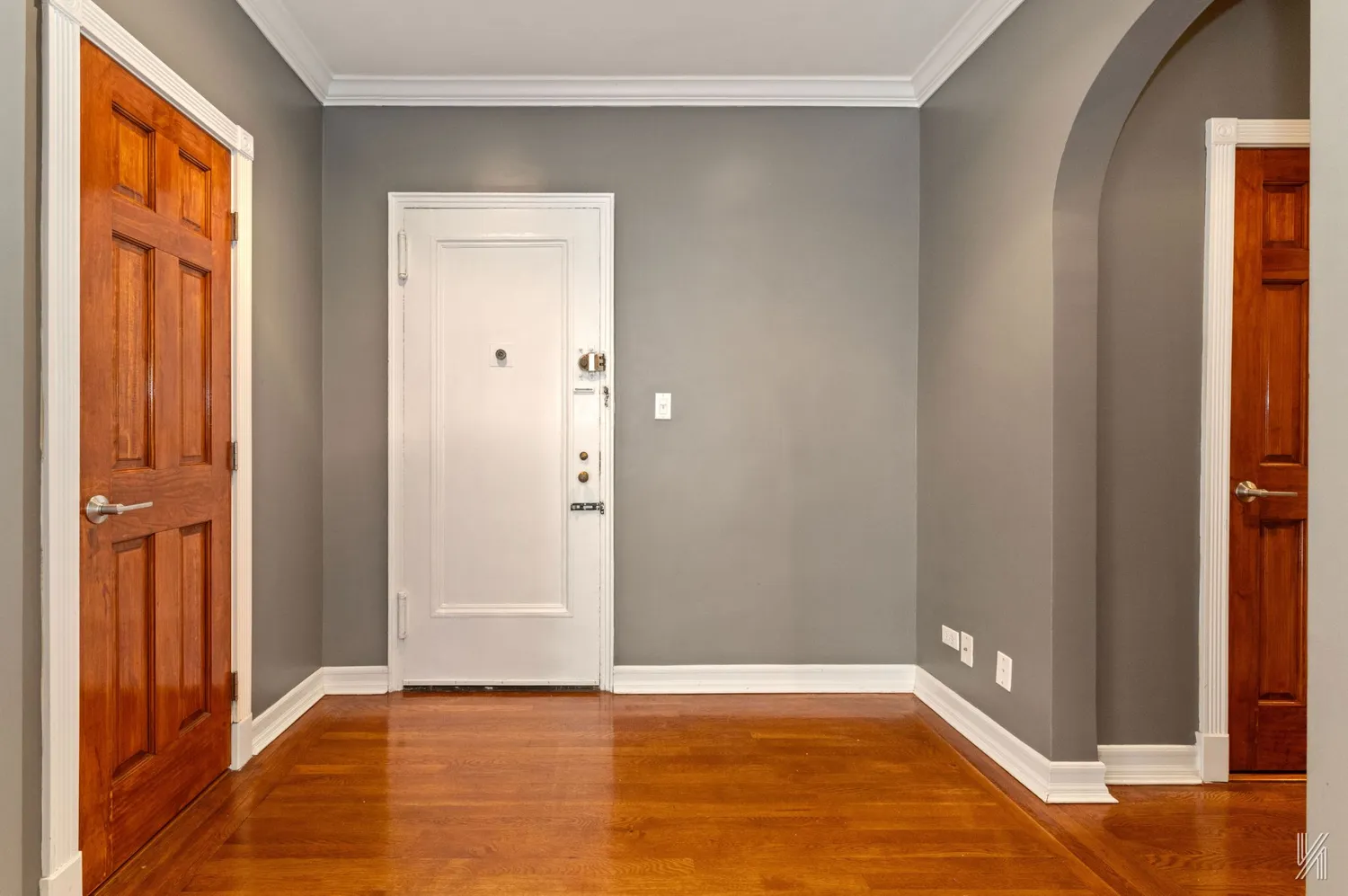a view of an empty room with wooden floor