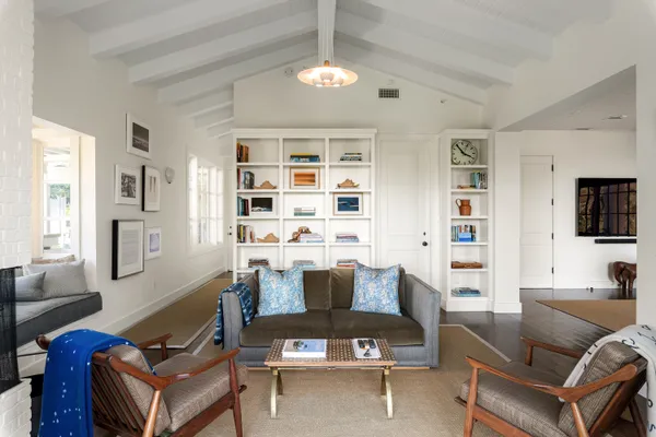 a view of a balcony with furniture and a floor to ceiling window