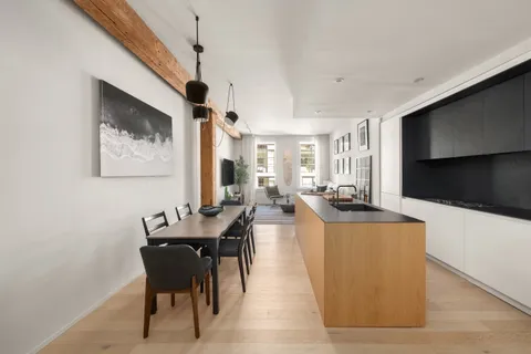 a view of a dining room with furniture and window
