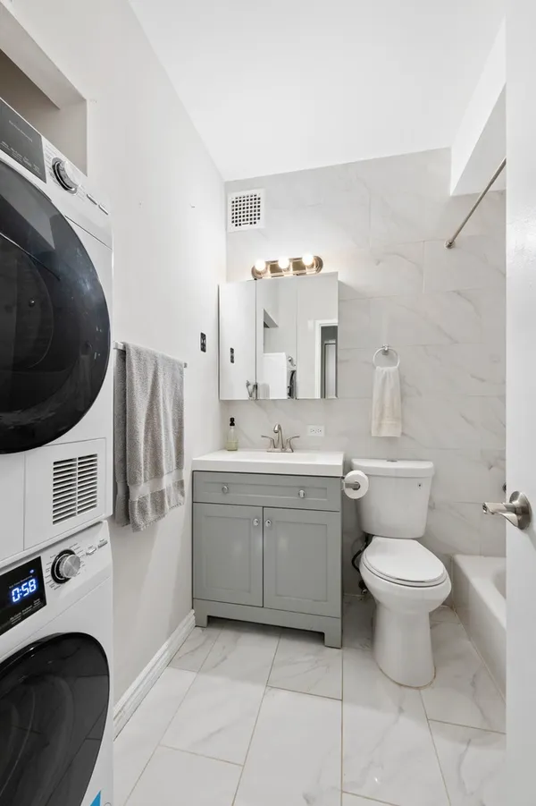 a bathroom with a sink toilet and a mirror