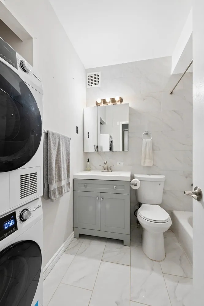 a bathroom with a sink toilet and a mirror