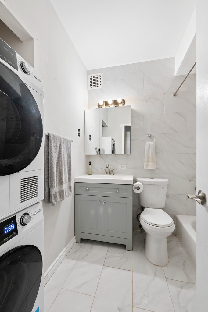 120 Manhattan Avenue, Unit 2A Manhattan, NY 10025 - Photo 7 of 10 a bathroom with a sink toilet and a mirror