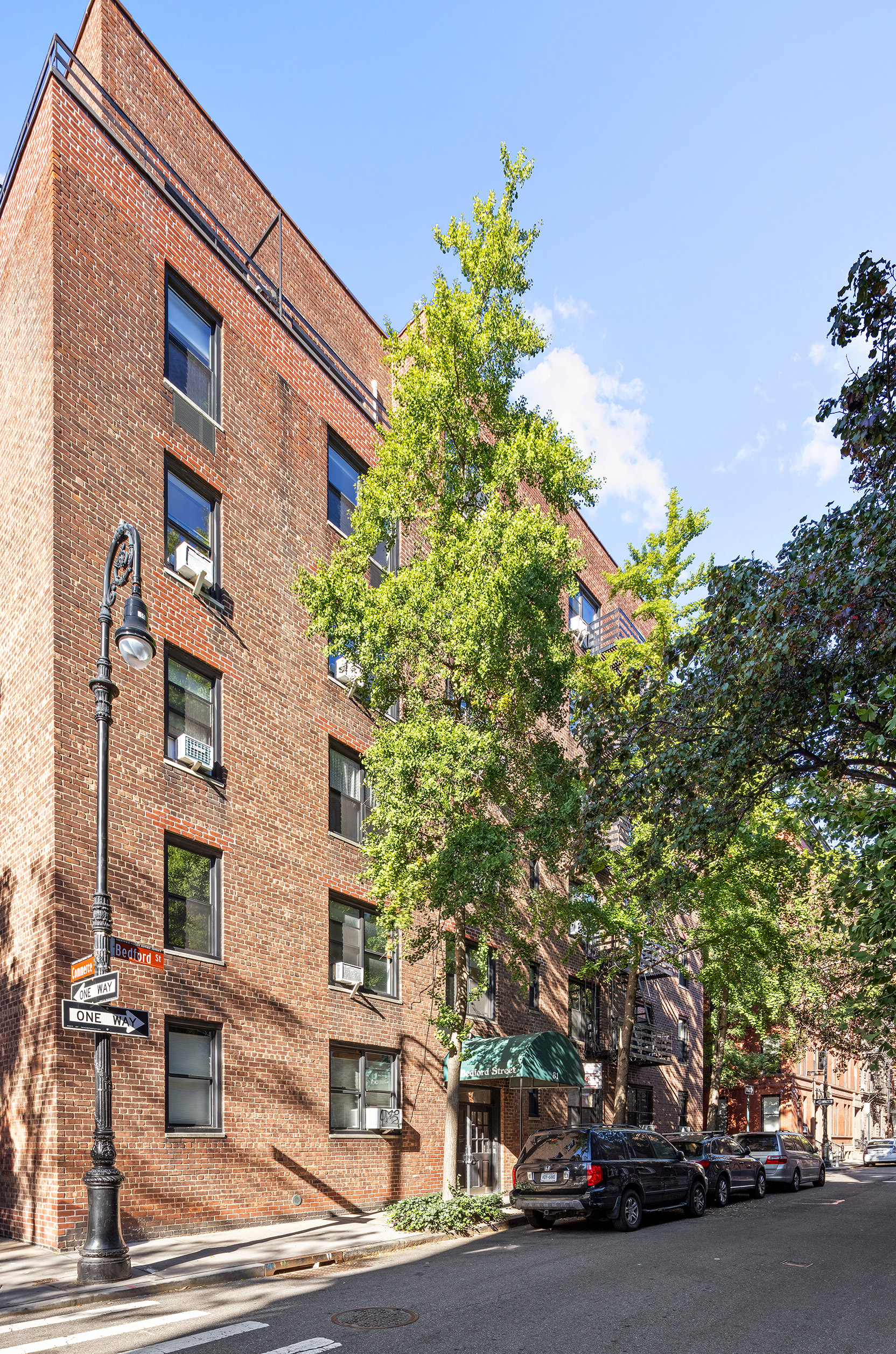 81 Bedford Street, Unit 4B Manhattan, NY 10014 - Photo 13 of 15 a city street lined with buildings and cars