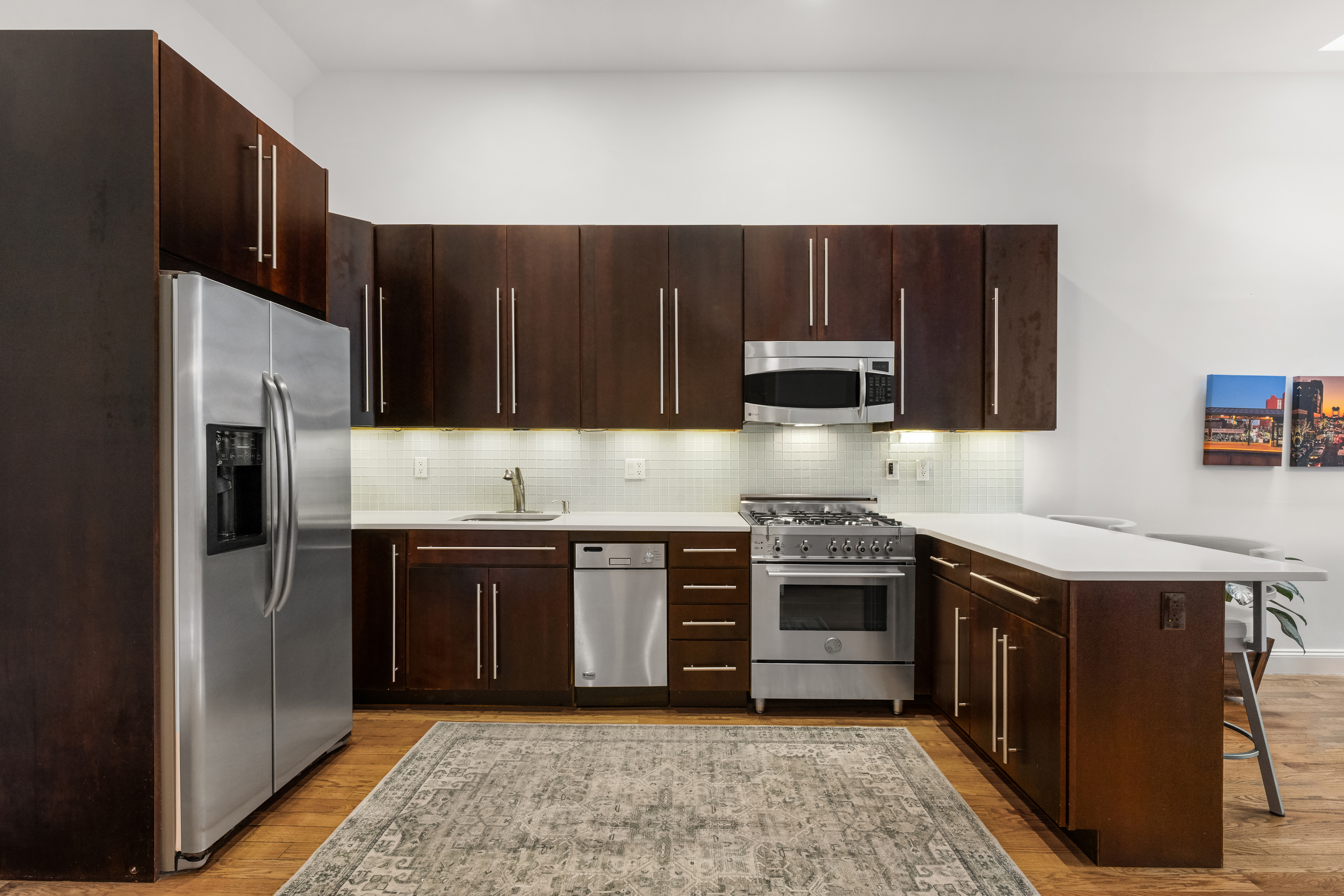 302 West 122nd Street, Unit 1 Manhattan, NY 10027 - Photo 5 of 13 a kitchen with stainless steel appliances granite countertop a refrigerator and a stove
