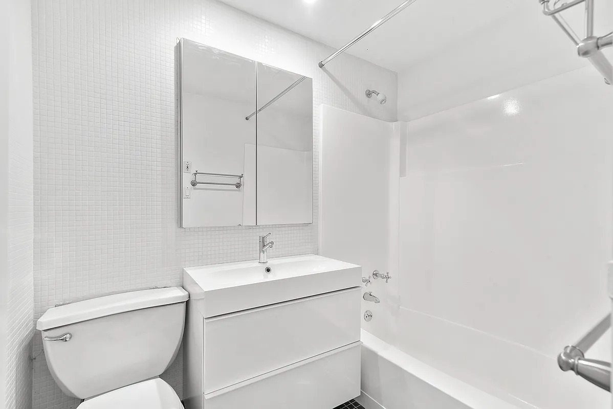 23 Waverly Place, Unit 6M Manhattan, NY 10003 - Photo 11 of 22 a bathroom with a sink toilet and shower