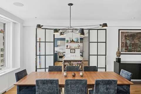 a living room with furniture a flat screen tv and a table