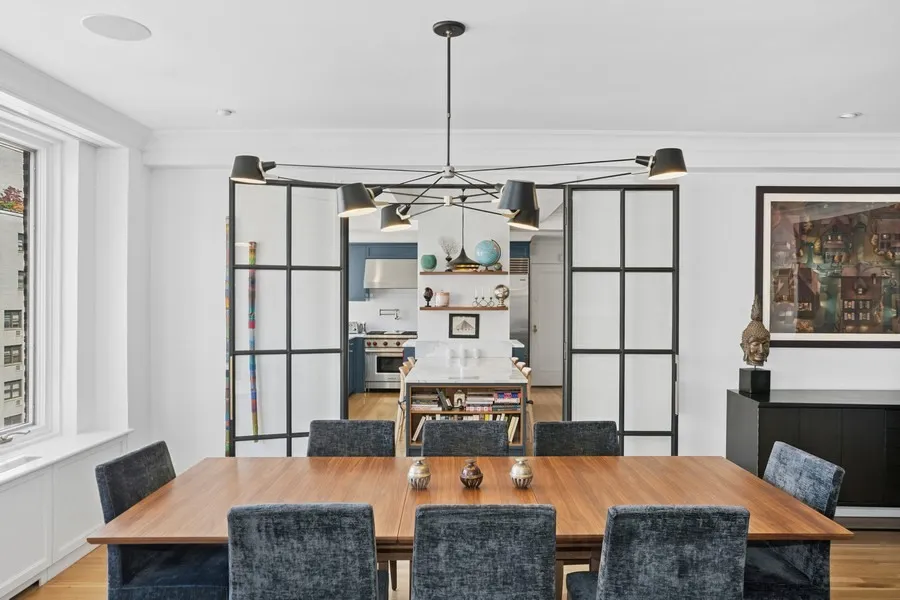 a living room with furniture a flat screen tv and a table
