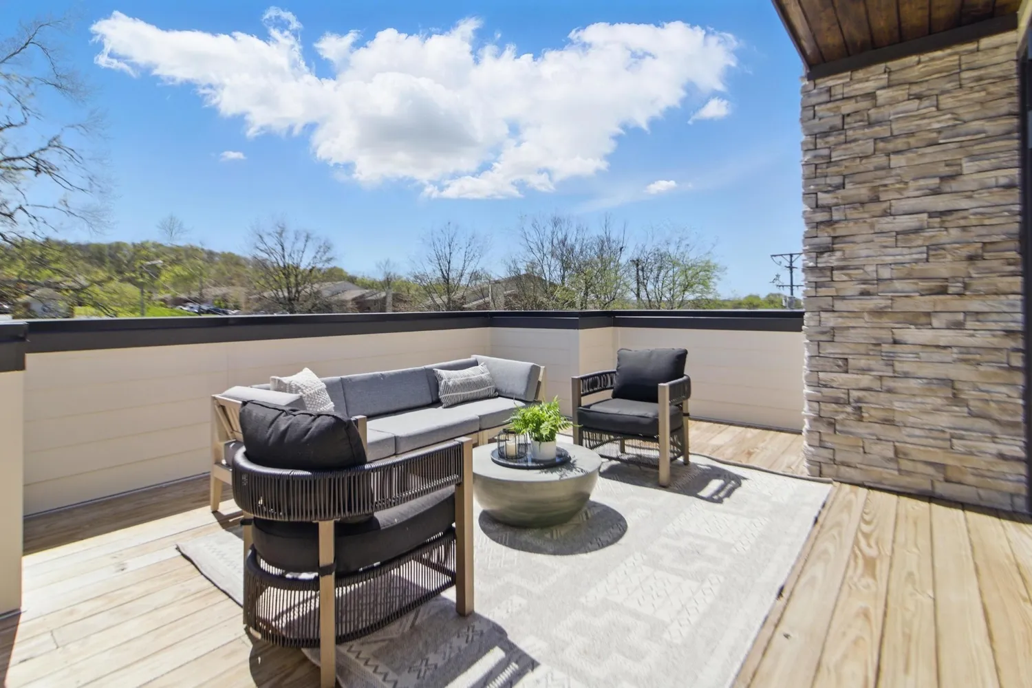 a view of a terrace with couches and lounge chairs