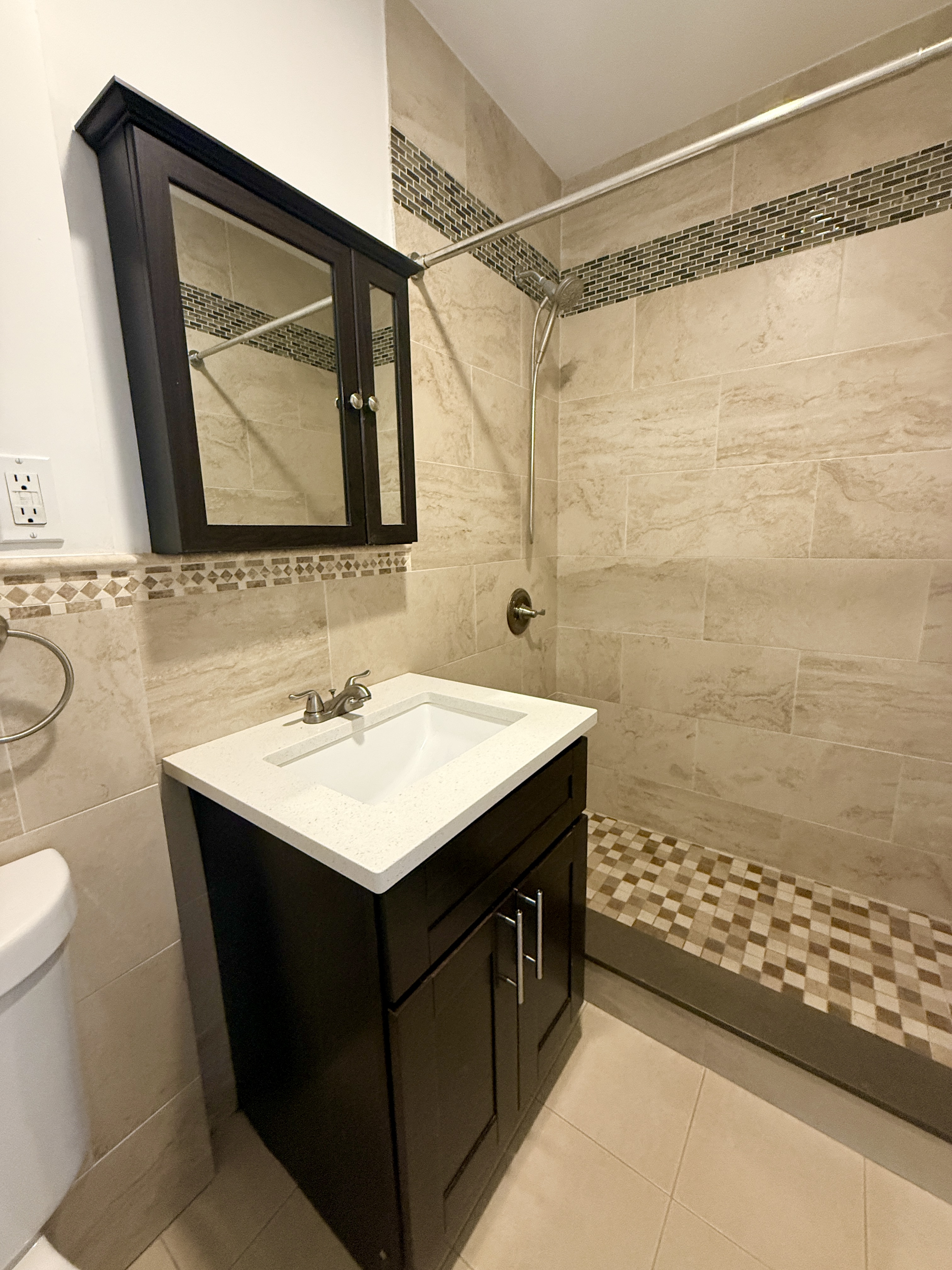 18-48 21st Drive, Unit 2R Queens, NY 11105 - Photo 4 of 7 a bathroom with a sink and a mirror