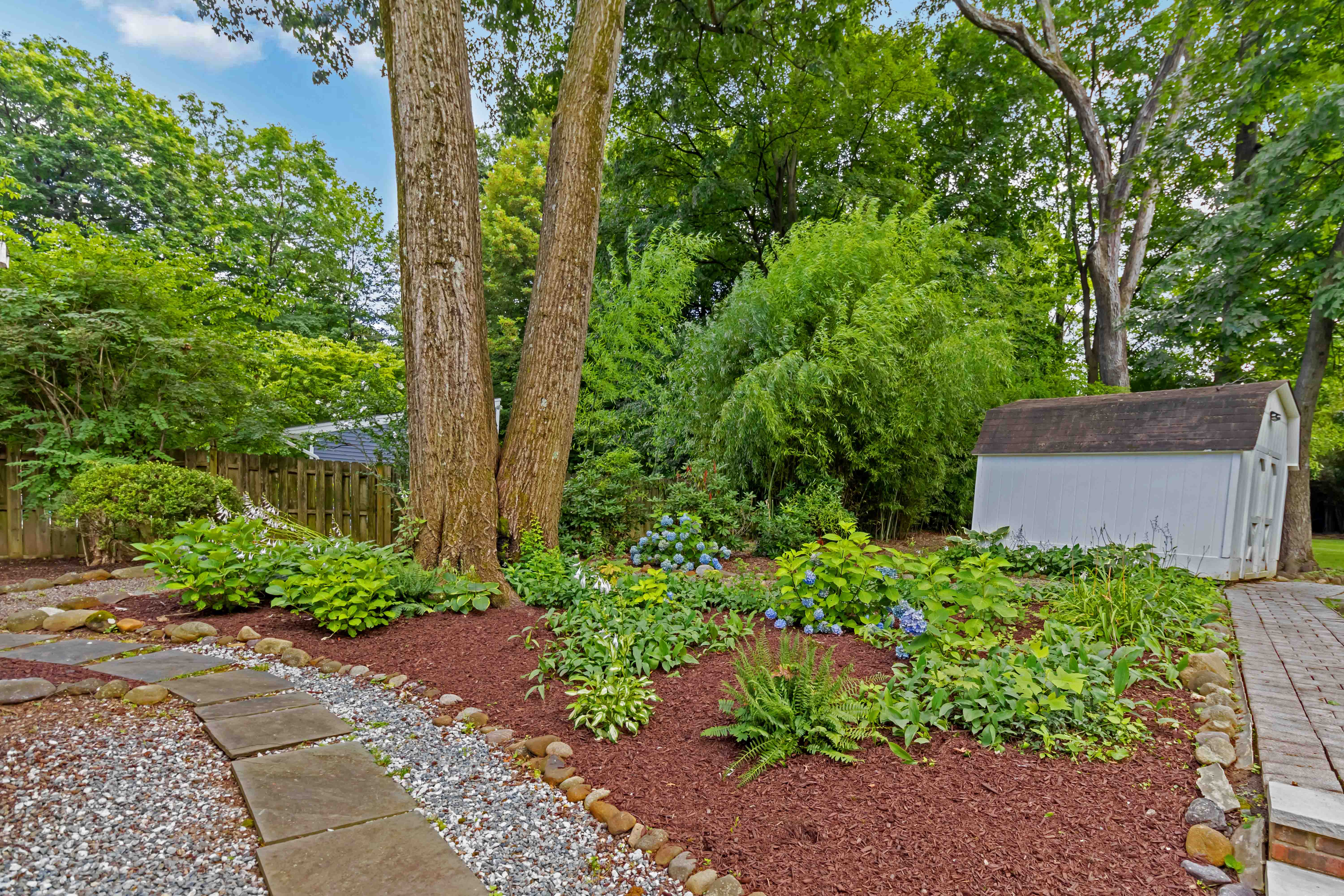 34 Colonial Drive Morristown, NJ 07960 - Photo 34 of 41 a view of a garden with plants and large trees