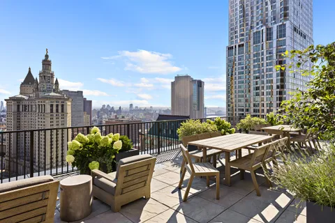 a view of a terrace with chairs and a potted plant