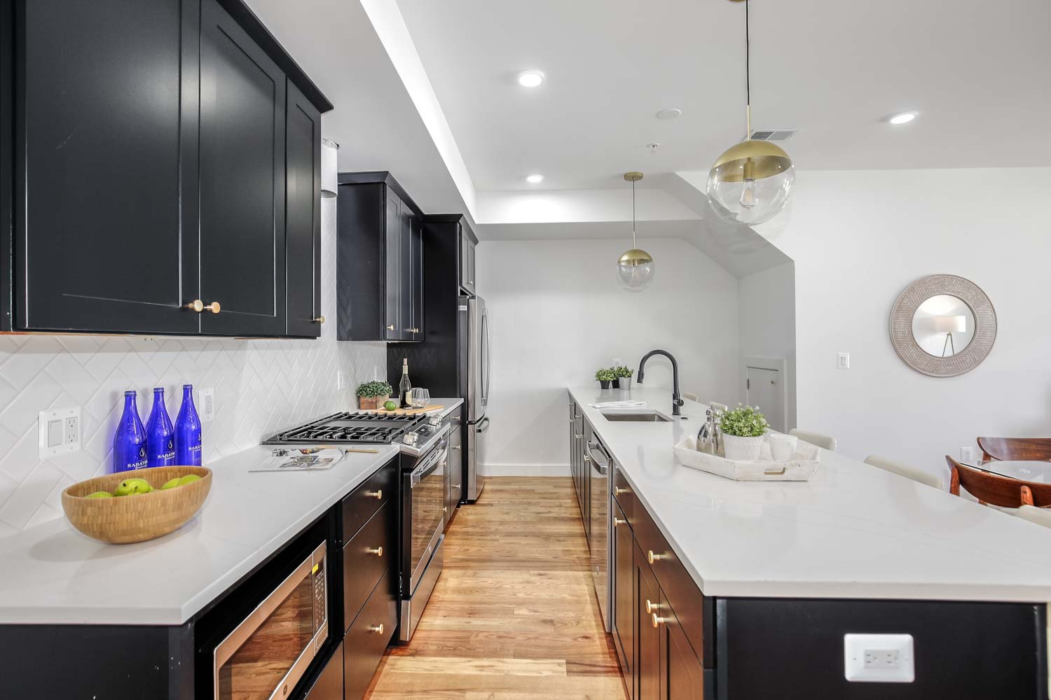 428 Manor Place Northwest, Unit 1 Washington, DC 20010 - Photo 7 of 27 a kitchen with a sink a stove and chairs with wooden floor