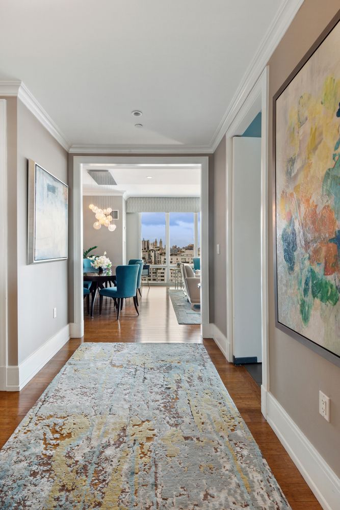 255 East 74th Street, Unit 20C Manhattan, NY 10021 - Photo 6 of 16 a view of a livingroom with furniture wooden floor and a flat screen tv