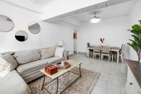 a living room with furniture and a rug