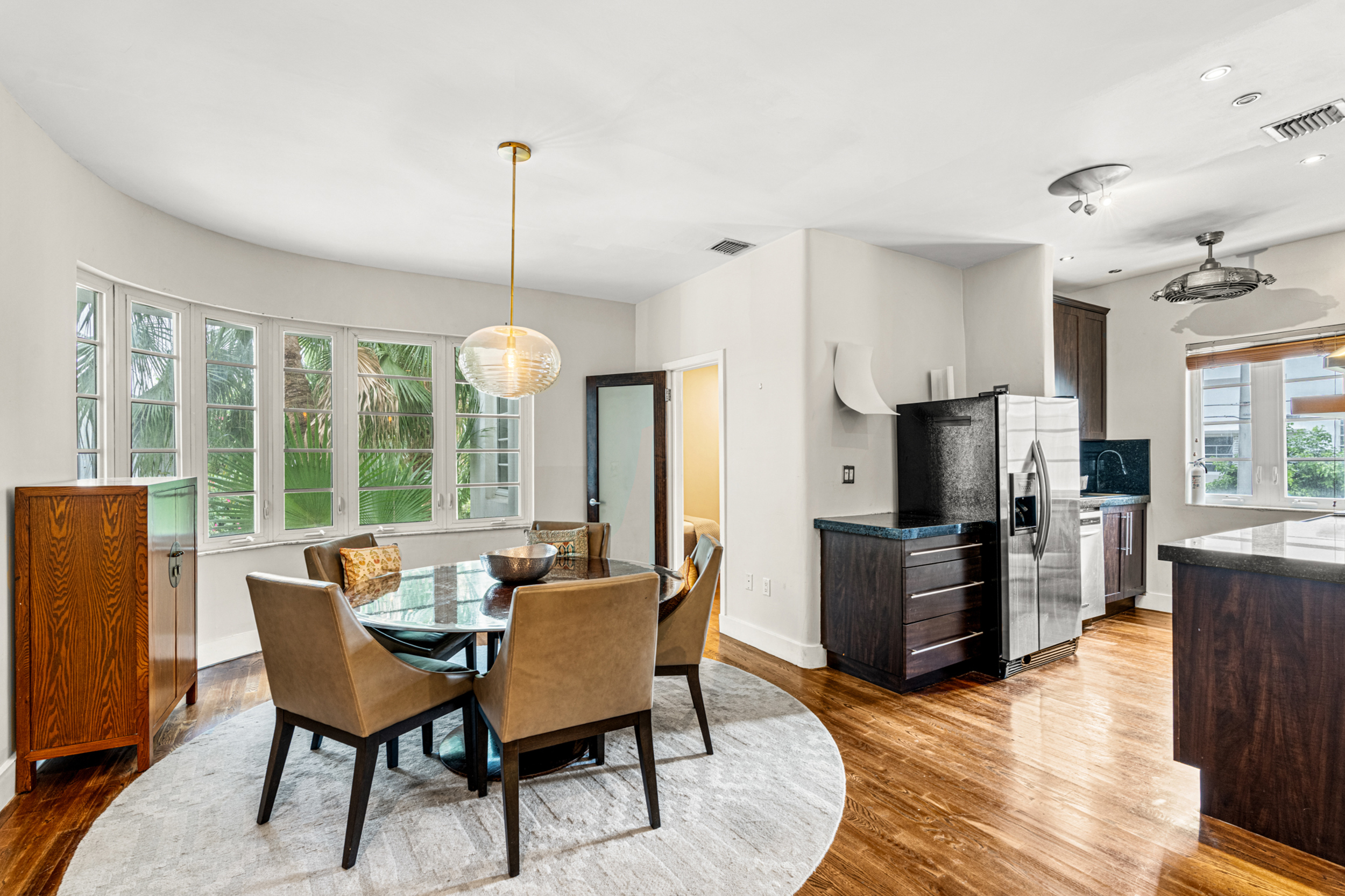 711 East 14th Street, Unit 7 Hialeah, FL 33010 - Photo 8 of 36 a dining room with furniture a chandelier and wooden floor
