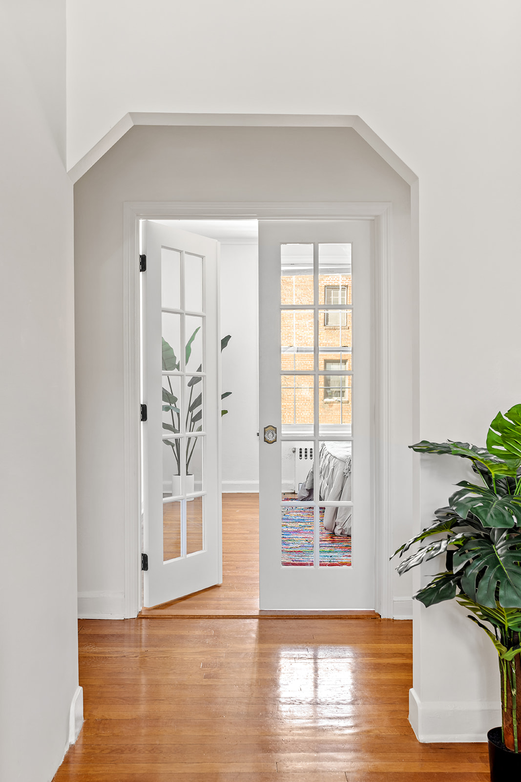 37-51 84th Street, Unit 21 Queens, NY 11372 - Photo 5 of 10 a view of empty room with wooden floor and potted plant
