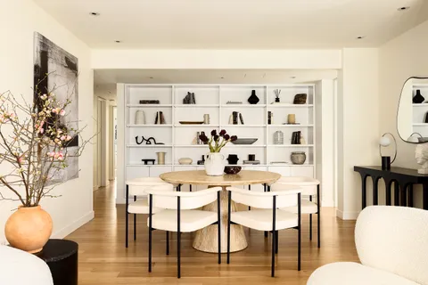 a dining room with furniture and wooden floor