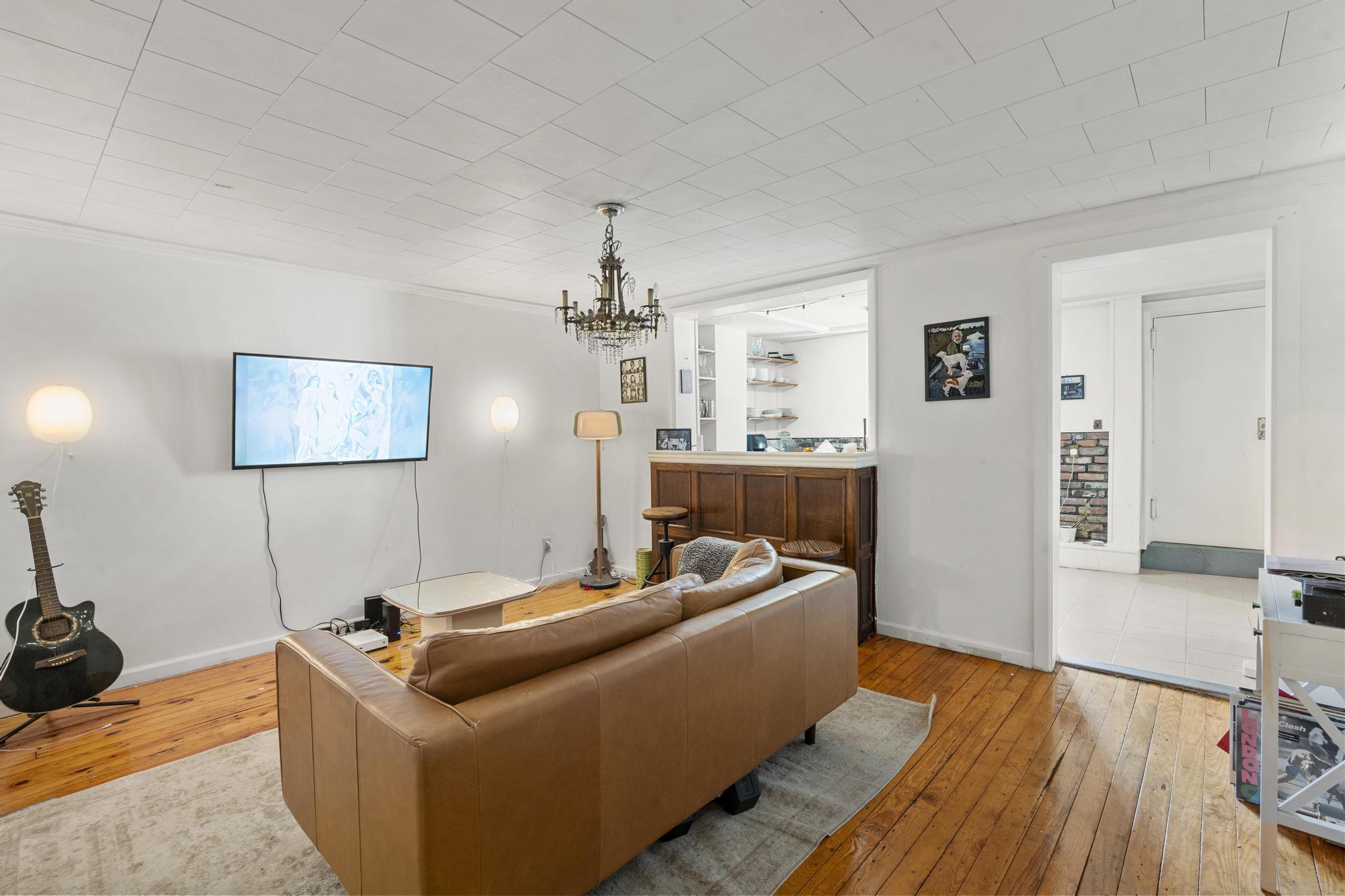 364 Clermont Avenue Brooklyn, NY 11238 - Photo 5 of 18 a living room with furniture and a wooden floor