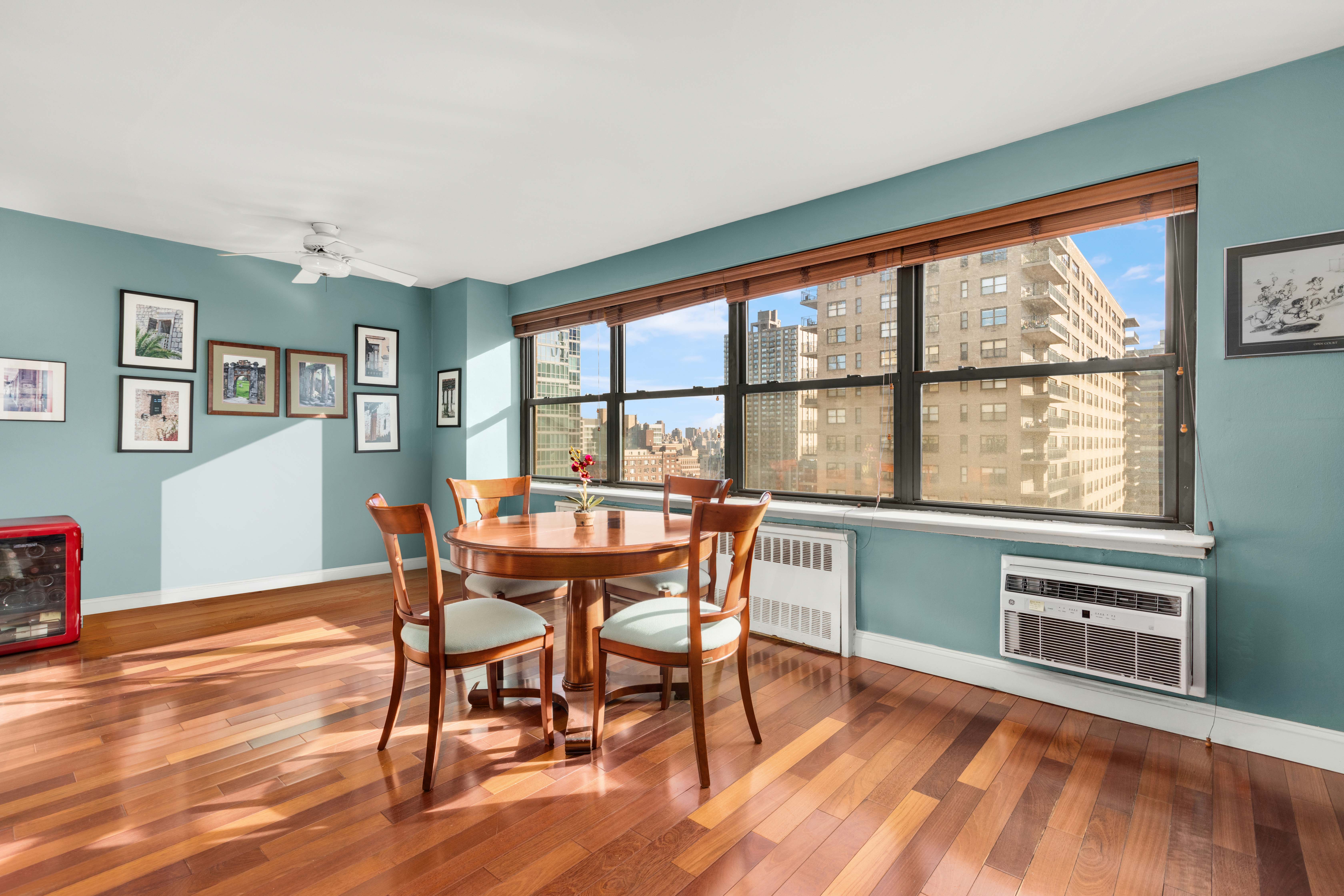 185 West End Avenue, Unit 24H Manhattan, NY 10023 - Photo 2 of 10 a dining room with furniture window wooden floor
