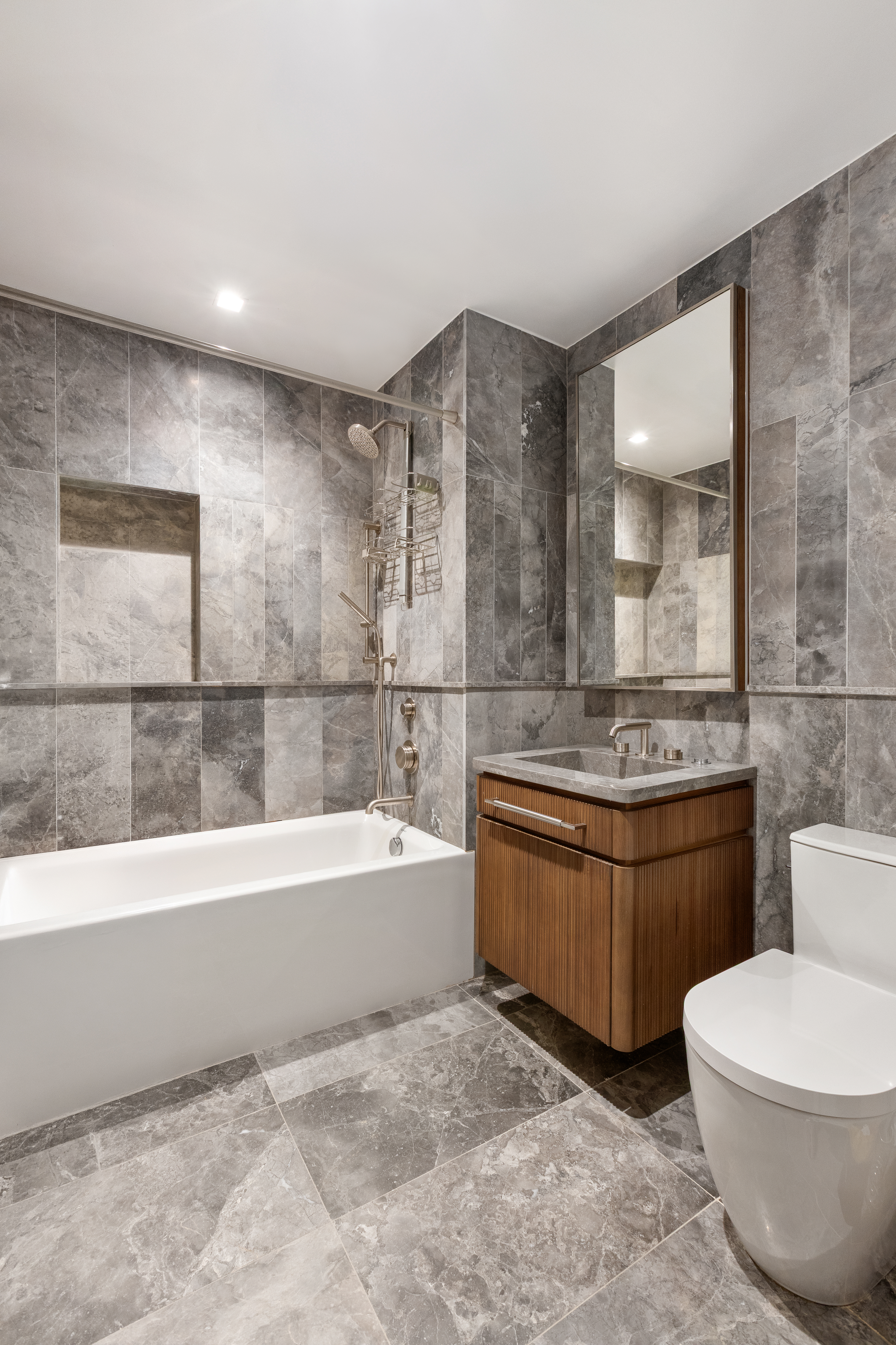 208 Delancey Street, Unit 3A Manhattan, NY 10002 - Photo 6 of 7 a spacious bathroom with toilet sink and bathtub