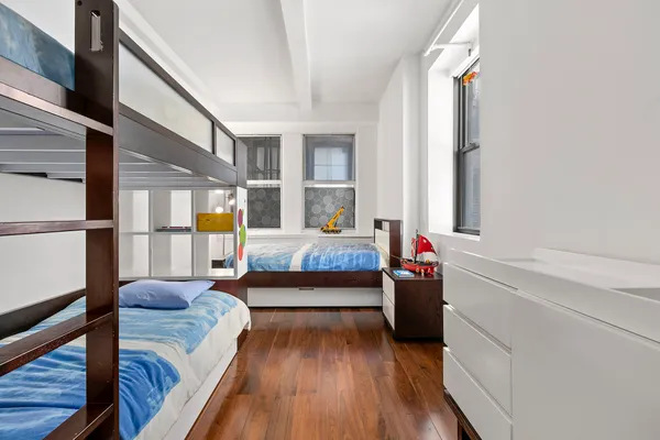 a bedroom with furniture and a wooden floor