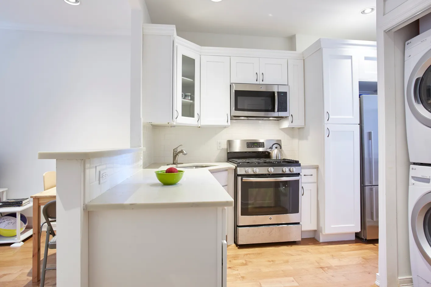 a kitchen with stainless steel appliances a stove a microwave and a sink