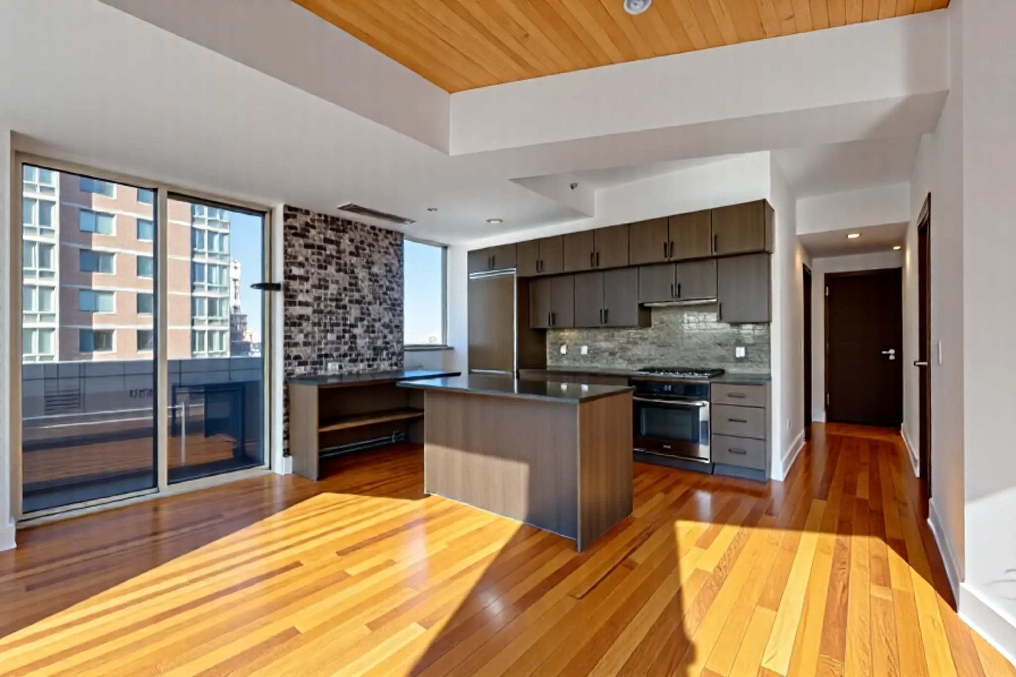 150 Myrtle Avenue, Unit 803 Brooklyn, NY 11201 - Photo 4 of 29 a kitchen with stainless steel appliances kitchen island granite countertop a refrigerator stove and oven