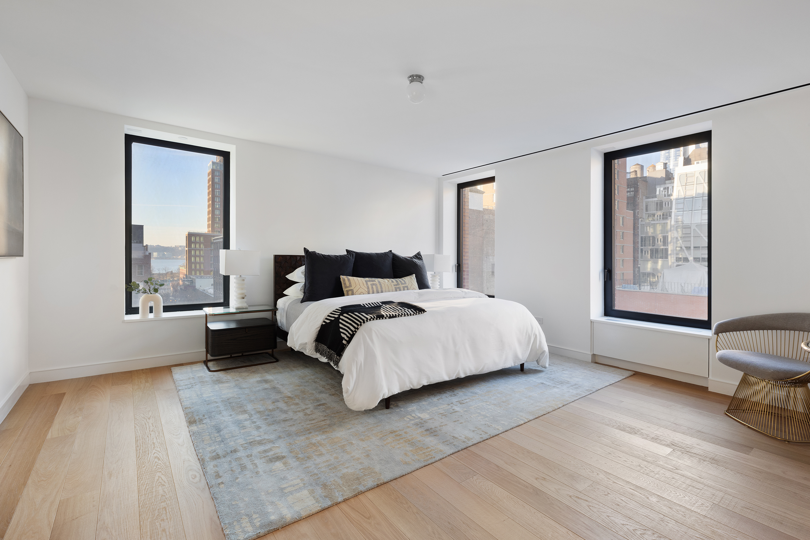 500 West 22nd Street, Unit 8W Manhattan, NY 10011 - Photo 16 of 27 a bedroom with a bed and a large window