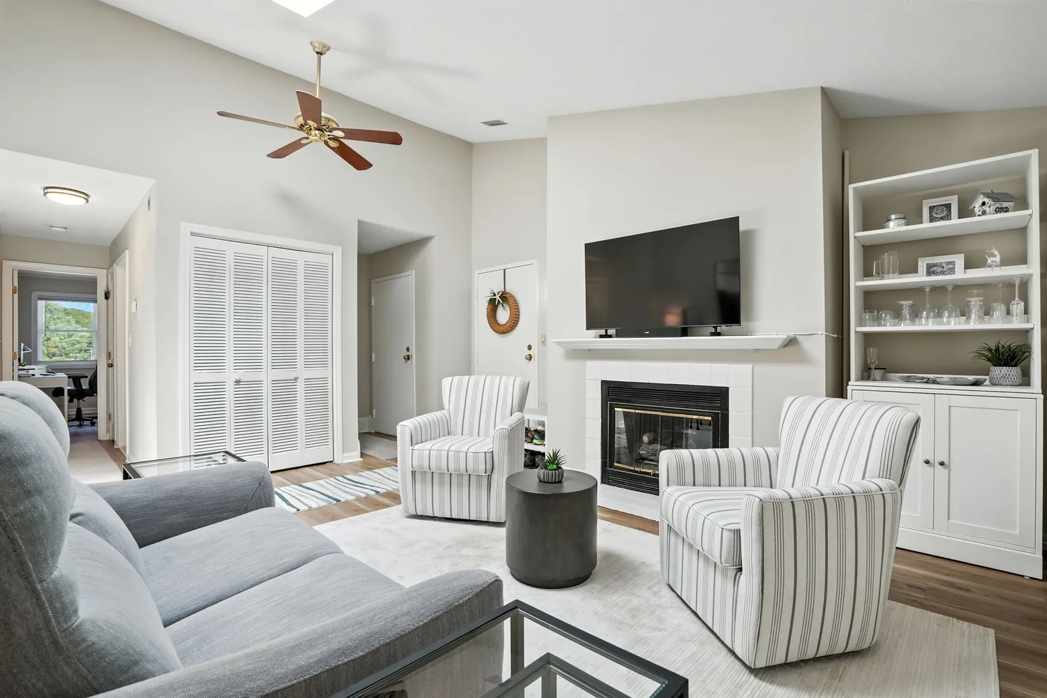 a living room with furniture a fireplace and a flat screen tv