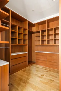 a view of walk in closet with empty racks