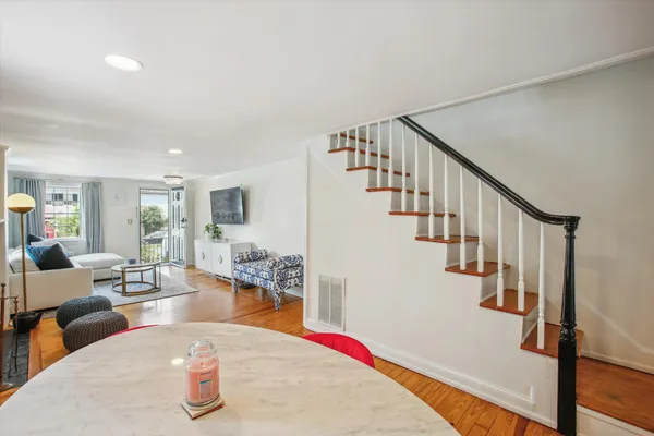 a living room with lots of furniture and wooden floor