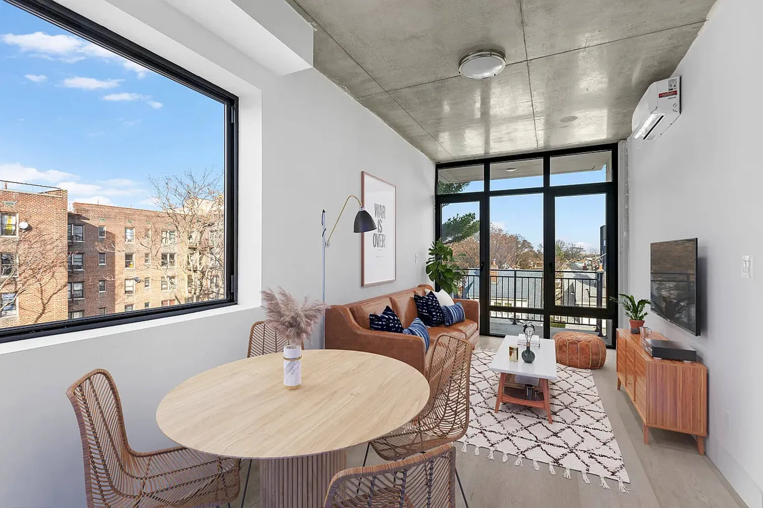 a kitchen with kitchen island stainless steel appliances a dining table chairs and sink