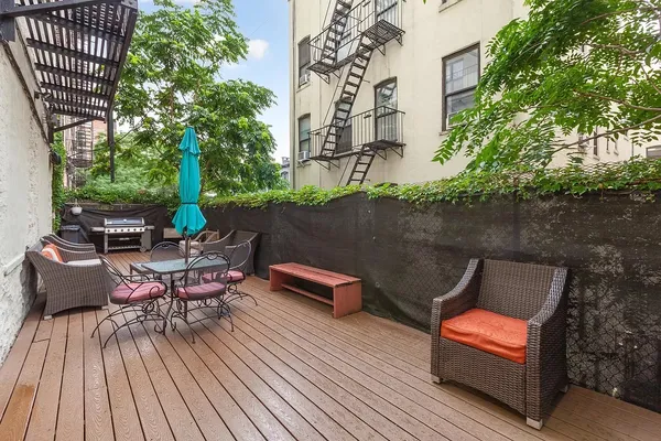 an outdoor sitting area with furniture and wooden floor