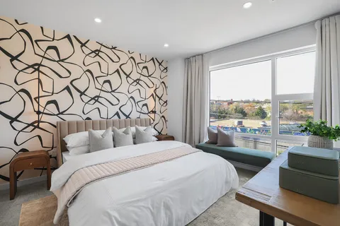 a bedroom with a large bed and a window